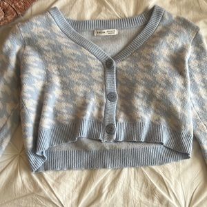 a blue/white long-sleeve with buttons from the middle down
